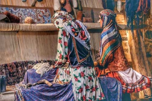 Nomad women weaving carpet in Iran